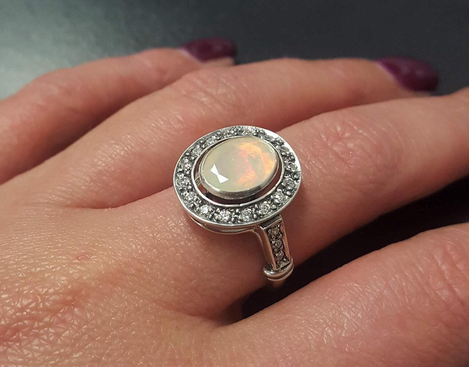White Opal oval bezel halo ring with Victorian vintage design in solid 925 sterling silver, featuring flashes of fire colors for energy and inspiration, perfect as an October birthstone gift and for engagements, anniversaries, or elegant celebrations.