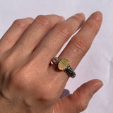 Fire Opal Ring styled on the index finger with bare nails, solid silver embossed band paired with radiant fire opal for a statement tribal look. A bohemian October Birthstone piece ideal for weddings, evening parties, and cultural gatherings