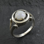 Australian Opal Ring in sterling silver featuring a round cabochon cut opal with flashes of fire colors. Australian opal is linked to creativity, inspiration, and emotional balance, making it a meaningful October birthstone gift. A thoughtful choice for birthdays, anniversaries, engagements, or promise rings. Perfect for daily wear, weddings, and elegant evening occasions.