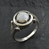 Australian Opal Ring in sterling silver featuring a round cabochon cut opal with flashes of fire colors. Australian opal is linked to creativity, inspiration, and emotional balance, making it a meaningful October birthstone gift. A thoughtful choice for birthdays, anniversaries, engagements, or promise rings. Perfect for daily wear, weddings, and elegant evening occasions.