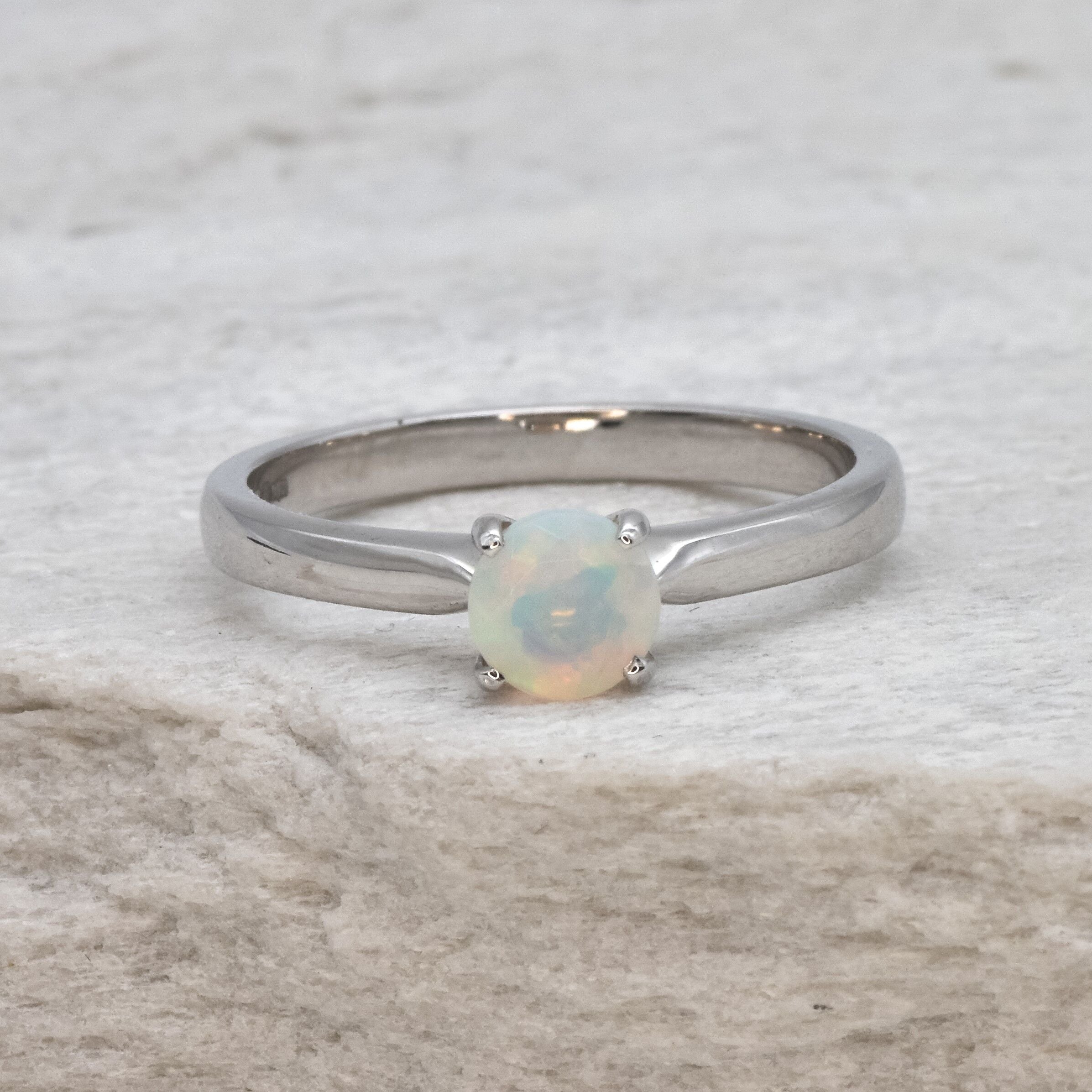 Natural Fire Opal solitaire ring set in 18k solid white gold, a timeless jewelry piece symbolizing creativity and passion, the perfect October birthstone gift for anniversaries, engagements, or milestone celebrations.