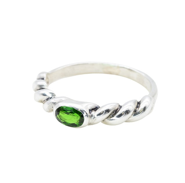 A twisted silver band with a vivid green gemstone, modern and artistic.