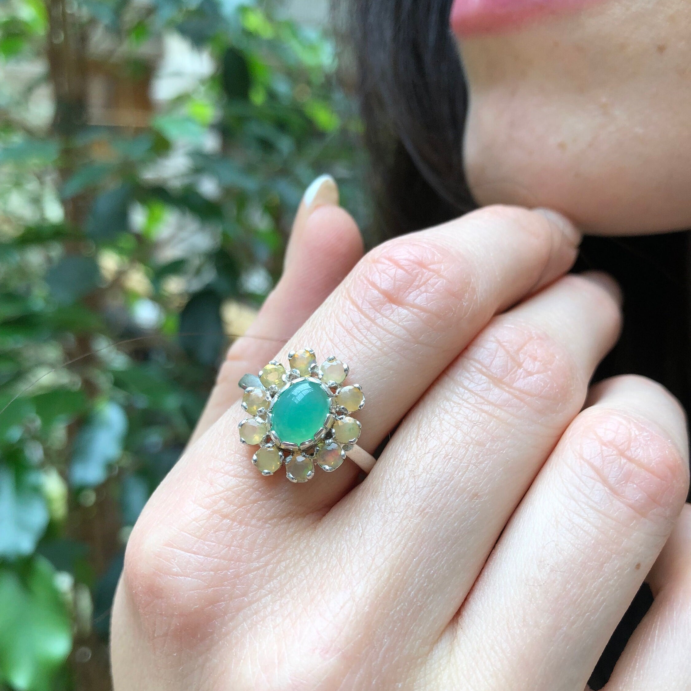 Flower Opal Ring with chrysoprase center worn on index finger with bare nails, radiating freshness and creativity, meaningful as an October birthstone gift, perfect for brunch outings and daytime gatherings.