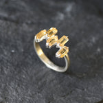 Modern minimalist ring with emerald-cut stones in a sleek sterling silver band.