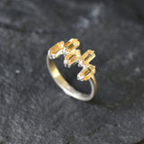 Modern minimalist ring with emerald-cut stones in a sleek sterling silver band.