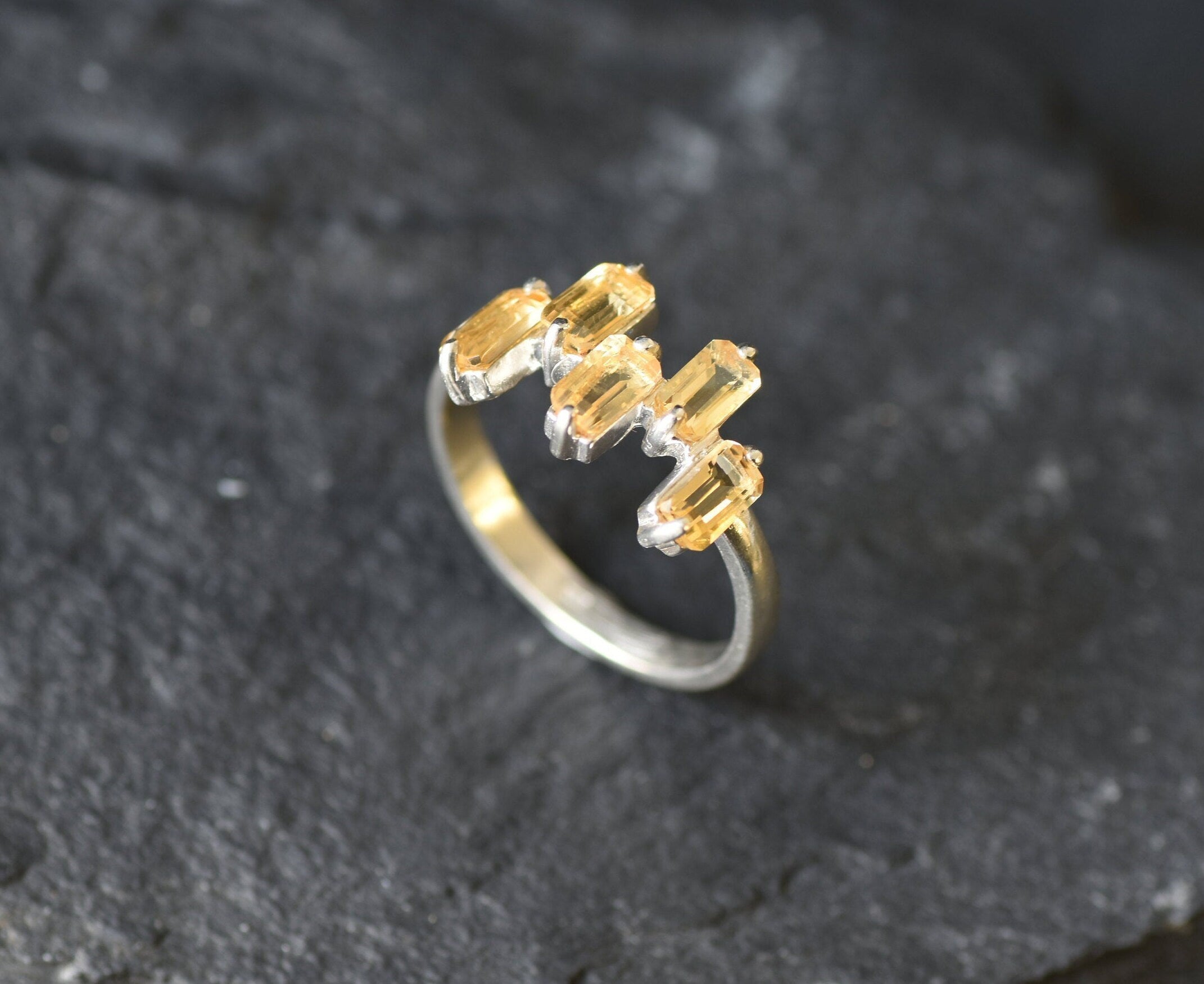 Modern minimalist ring with emerald-cut stones in a sleek sterling silver band.