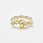 Fire Opal bypass ring in sterling silver with cabochon cut gemstones showcasing flashes of fire colors, crafted in a dainty jewelry style, believed to inspire joy and passion, a meaningful October birthstone gift idea for engagements, birthdays, and cocktail parties.