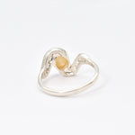 Fire Opal bezel wave ring with CZ pave in sterling silver, featuring flashes of rainbow fire colors, designed in a dainty jewelry style symbolizing passion and hope, a powerful October birthstone gift idea for engagements, anniversaries, and special occasions.