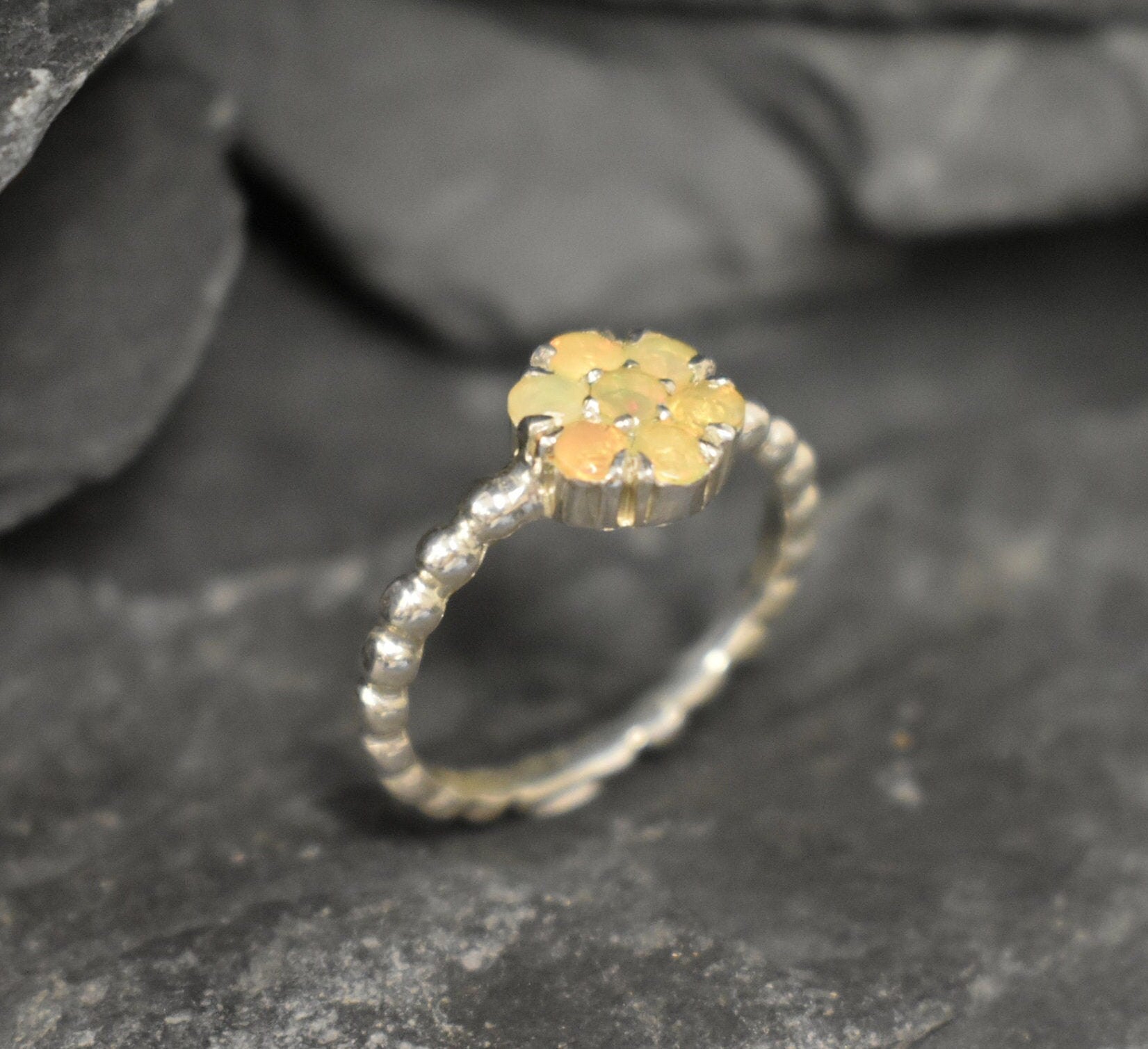 Flower Fire Opal Ring in solid 925 Sterling Silver with dainty bubble band style, designed with flashes of fire colors. Known for its energy of inspiration and positivity, this October birthstone makes a meaningful gift idea for nature lovers and those who adore dainty jewelry styles.
Perfect for anniversaries, birthdays, weddings, and romantic evening events.