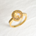 Ethiopian Opal diamond cut halo ring in gold, surrounded by sparkling CZ accents for brilliance and elegance. The halo design highlights flashes of fire colors while offering timeless durability. As the October Birthstone, Opal makes a meaningful gift for birthdays, engagements, anniversaries, or personal milestones. Perfect to wear at weddings, cocktail parties, and festive gatherings.