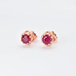 Natural Ruby Flower Earrings set in Solid 14k Rose Gold, in a prong setting, round cut, and natural red color. July birthstone earrings symbolizing real love and success. Dainty red ruby studs perfect for everyday wear