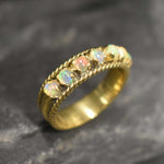 Opal Rope Row Ring featuring cabochon cut stones that highlight flashes of fire colors, offering elegance and timeless jewelry style. Known for enhancing inspiration and emotional balance, this October birthstone ring makes a meaningful gift idea. Perfect for birthdays, anniversaries, and cherished events, it can be worn to weddings, evening parties, or daily gatherings with sophistication.