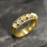 Opal Rope Row Ring featuring cabochon cut stones that highlight flashes of fire colors, offering elegance and timeless jewelry style. Known for enhancing inspiration and emotional balance, this October birthstone ring makes a meaningful gift idea. Perfect for birthdays, anniversaries, and cherished events, it can be worn to weddings, evening parties, or daily gatherings with sophistication.
