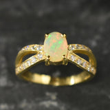 Opal Ring with split shank band and CZ pave setting showing flashes of fire colors, designed as elegant fine jewelry. Known for its emotional healing and creativity benefits, Opal is also the October birthstone and a thoughtful gift for birthdays or anniversaries. Perfect to wear at weddings, romantic dinners, and special evening celebrations.