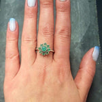 Emerald Flower Ring worn on middle finger with light blue gradient nails. The ring features a floral cluster of genuine emeralds in sterling silver. Emerald is the May birthstone linked to love, harmony, and renewal, making it a meaningful gift for birthdays, anniversaries, or promise occasions. Perfect to wear for weddings, family gatherings, and elegant parties.