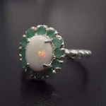 Opal halo floral ring with Genuine Emeralds in a vintage victorian flower halo, White cabochon center, and beaded Bubble Band for a bold statement cocktail look showing flashes of fire colors. Benefits include creativity, harmony, and calm. Ideal October birthstone gift with meaningful May emerald accents.
Worn for weddings, cocktail parties, anniversaries, graduations, garden events, and holiday gatherings.