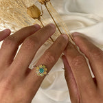 Emerald Opal Flower Ring worn on index finger with short natural nails. Jewelry style is floral and feminine with a polished sterling silver band. Emerald brings renewal and harmony while Opal enhances inspiration and creativity. A thoughtful birthstone gift for May and October birthdays or anniversaries. Perfect for weddings, elegant dinners, and casual chic outfits.