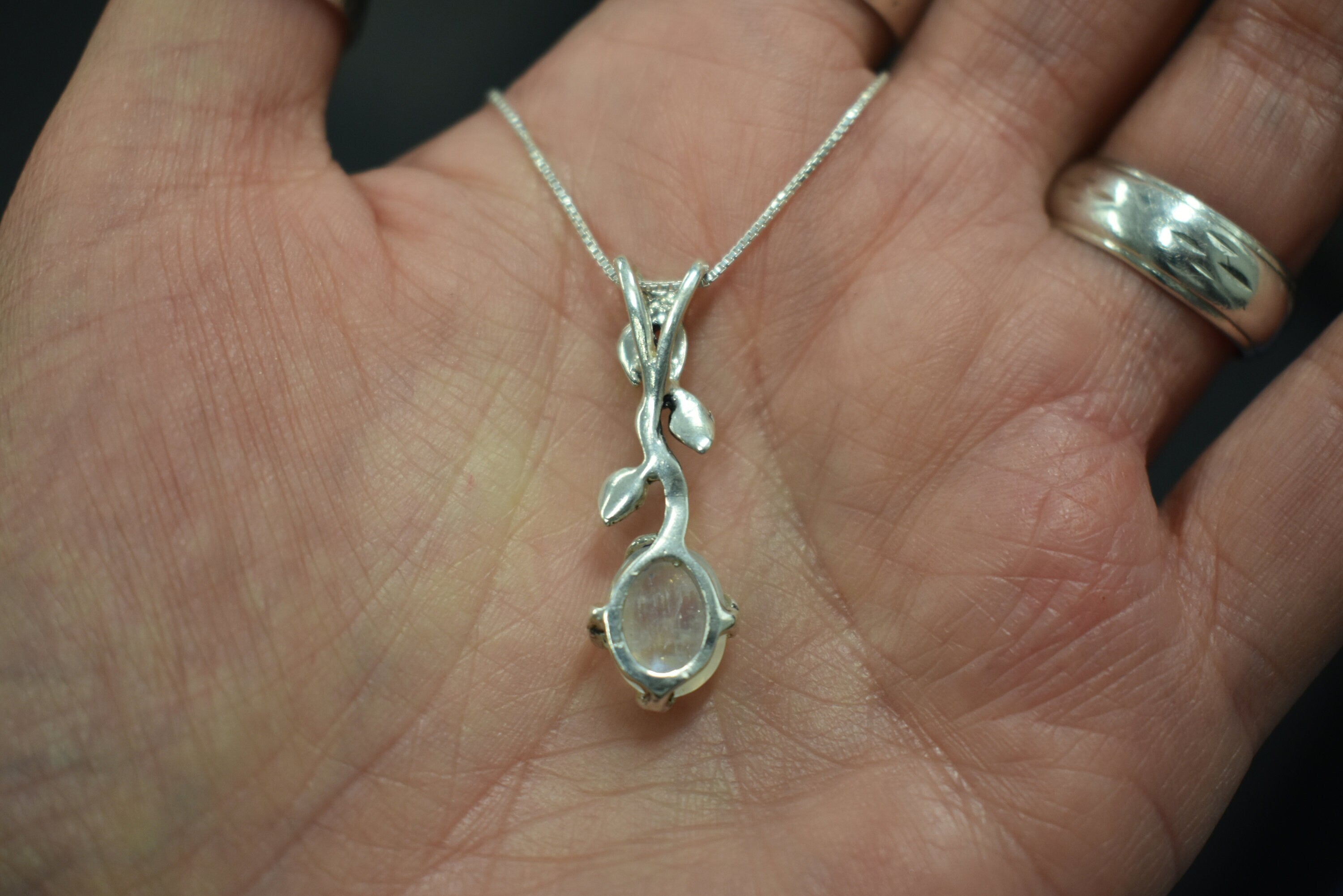 Elegant handcrafted moonstone pendant with nature-inspired silver vine design