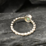 Fire Opal bezel bubble band ring in sterling silver with flashes of fire colors, a dainty jewelry style perfect for everyday elegance and stacking. Offers the benefit of durability with bezel setting and a glowing October birthstone gift idea for loved ones. Ideal to wear for birthdays, anniversaries, engagements, or casual celebrations.