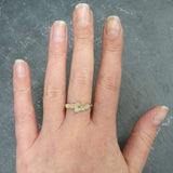 Ethiopian Fire Opal Bypass Ring with cabochon gems worn on middle finger with natural nails, radiating flashes of fire colors, styled with minimalistic outfits, perfect for office gatherings, cocktail parties, and wedding receptions.