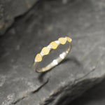 Yellow Ethiopian Fire Opal half eternity band ring in sterling silver with diamond cut stones set in a row, showcasing flashes of fire colors in a dainty jewelry style. Offers the benefit of a sleek eternity design with bright opals for durability and charm, making it a meaningful October birthstone gift. Perfect for weddings, anniversaries, birthdays, and daily wear.