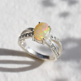 Natural Fire Opal diamond cut in a split sterling silver band with sparkling CZ Diamond accents offering vibrant energy and charm perfect as an October birthstone gift for engagements anniversaries or special celebrations.