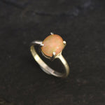 Ethiopian Fire Opal Solitaire Ring in sterling silver with a cabochon cut oval stone showing flashes of fire colors. Opal is linked to creativity, inspiration, and emotional balance, making it a meaningful October birthstone gift. A thoughtful choice for birthdays, anniversaries, promise rings, or engagements. Suitable for daily wear, weddings, and classic elegant occasions.