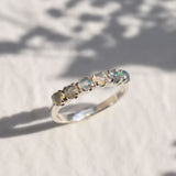 Natural Fire Opal cabochon half eternity ring in solid 925 sterling silver, designed with dainty cabochon stones for timeless elegance and flashes of fire colors. This ring highlights durability and everyday wear while being lightweight and comfortable. As the October Birthstone, Fire Opal makes a meaningful gift for birthdays, anniversaries, or special occasions. Perfect to wear at weddings, cocktail parties, and festive celebrations.