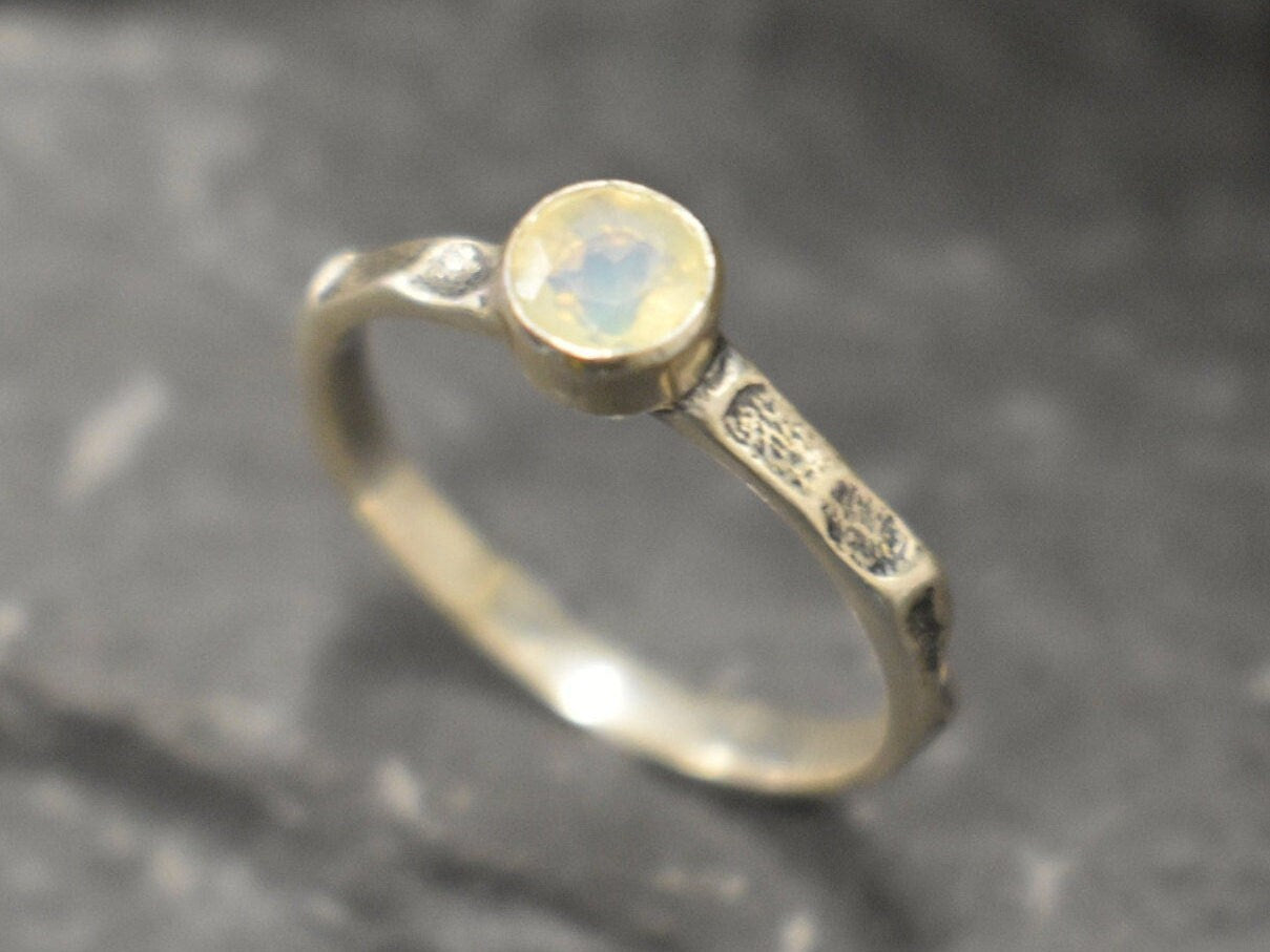 Ethiopian Opal ring in a dainty boho solitaire with a hammered band and oxidized silver bezel showing flashes of fire colors; the protective bezel and textured finish are comfortable for daily wear and help hide small scratches. Thoughtful October Birthstone gift for meaningful minimalist jewelry lovers.
Worn for office days, brunch dates, music festivals, casual weekends, and small weddings.