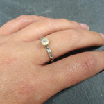 Ethiopian Opal Hammered Solitaire Ring worn on the middle finger with nude nails, paired with a white linen sundress and strappy sandals; the oxidized silver bezel keeps it low profile and secure for all-day errands; perfect for brunch, farmers markets, and park picnics.Worn for office days, brunch dates, music festivals, casual weekends, and small weddings.