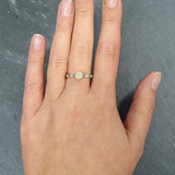 Ethiopian Opal Hammered Solitaire Ring styled with a black scoop blouse and high-rise jeans, worn on the index finger with bare nails; flashes of fire colors add subtle shimmer while the bezel offers everyday durability; ideal for date nights, concerts, and rooftop dinners.Worn for office days, brunch dates, music festivals, casual weekends, and small weddings.