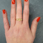 Flower Opal Ring worn on middle finger with natural nails, crafted with six cabochon stones in a curved bypass band, symbolic as an October birthstone gift, ideal for anniversaries and elegant dinner dates.