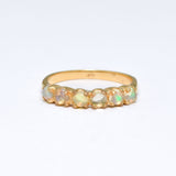 Ethiopian Opal eternity ring in gold with round cabochon gemstones, ideal for stacking or wearing solo, symbolizing everlasting love and inspiration, a meaningful October birthstone gift for weddings, anniversaries, and romantic milestones.