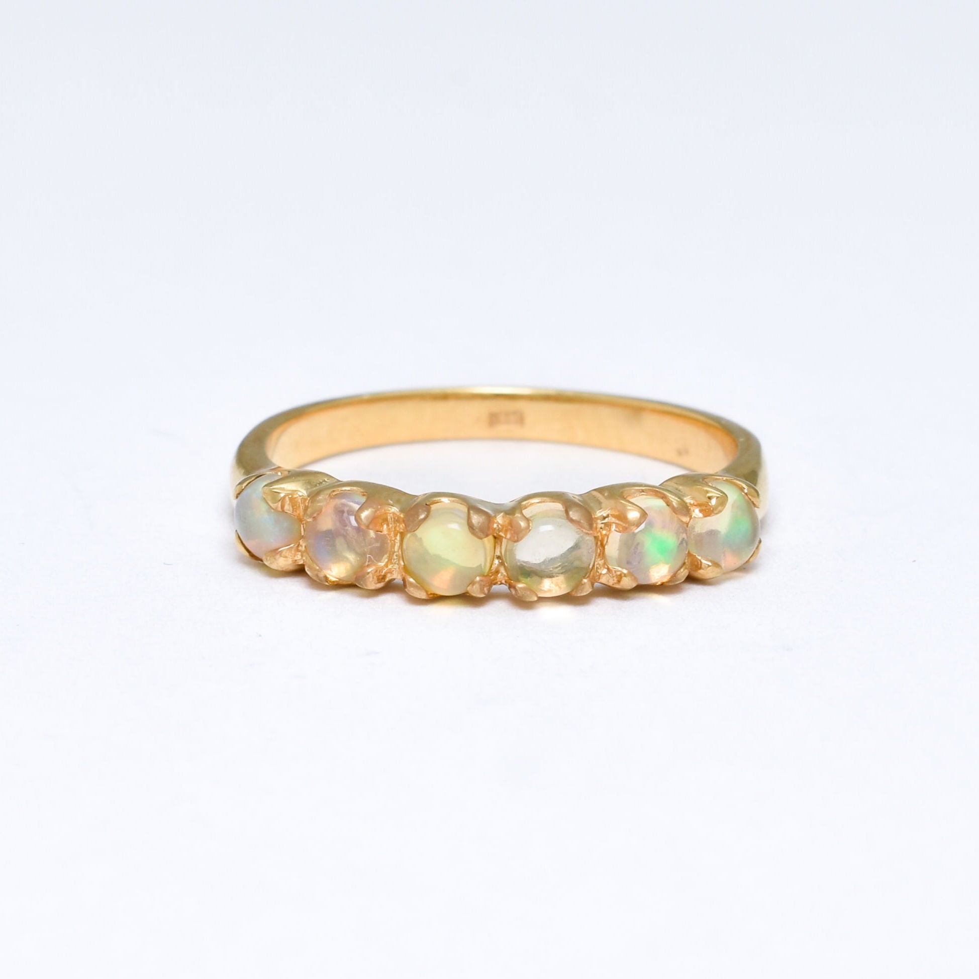 Ethiopian Opal eternity ring in gold with round cabochon gemstones, ideal for stacking or wearing solo, symbolizing everlasting love and inspiration, a meaningful October birthstone gift for weddings, anniversaries, and romantic milestones.