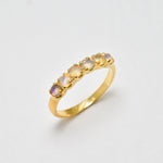 Ethiopian Opal eternity ring in gold with round diamond cut stones, ideal for stacking or wearing solo, symbolizing endless love and inspiration, a meaningful October birthstone gift for weddings, anniversaries, and milestone celebrations.