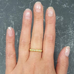 Ethiopian Opal Eternity Ring worn on ring finger with nude nails, perfect for symbolizing eternal love and believed to inspire hope, ideal for anniversaries and romantic celebrations.