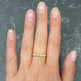 Ethiopian Opal Eternity Ring worn on ring finger with nude nails, perfect for symbolizing eternal love and believed to inspire hope, ideal for anniversaries and romantic celebrations.