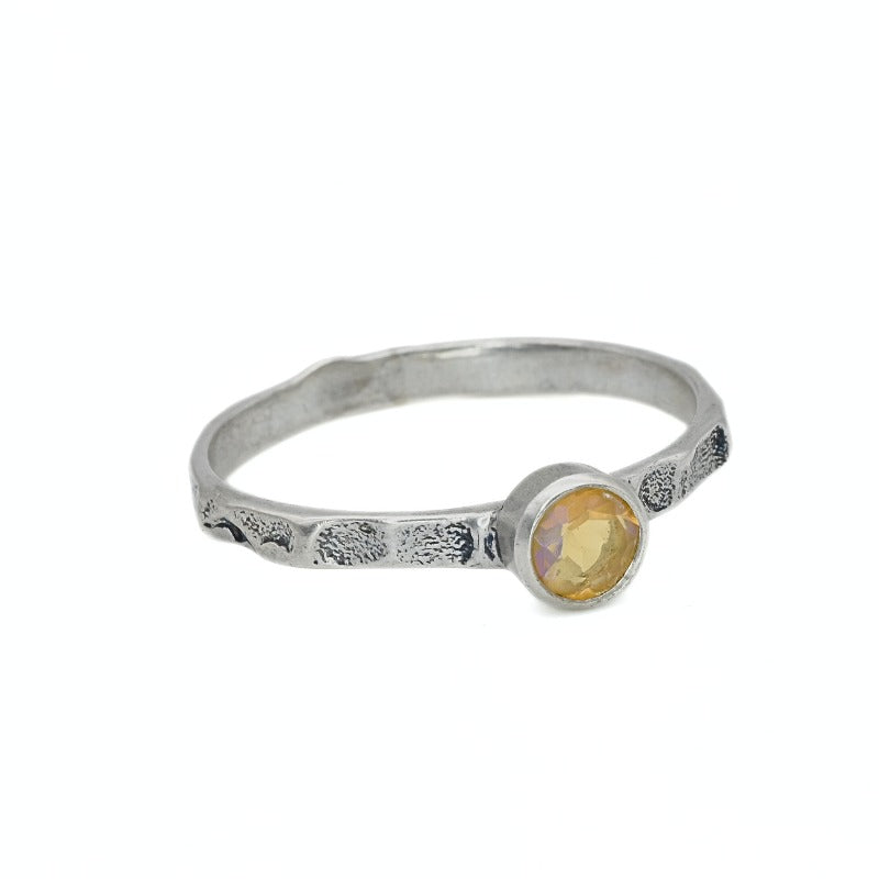 Ethiopian Opal ring in a dainty boho solitaire with a hammered band and oxidized silver bezel showing flashes of fire colors; the protective bezel and textured finish are comfortable for daily wear and help hide small scratches. Thoughtful October Birthstone gift for meaningful minimalist jewelry lovers.
Worn for office days, brunch dates, music festivals, casual weekends, and small weddings.