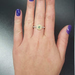 Fire Opal Flower Ring styled on middle finger with deep purple nail polish, showcasing its flashes of fire colors against the sterling silver bubble band. Known for uplifting moods and inspiring originality, this October birthstone gift idea is a nature-inspired treasure. Perfect for autumn weddings, evening soirées, and milestone celebrations.