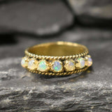 Opal Rope Row Ring featuring cabochon cut stones that highlight flashes of fire colors, offering elegance and timeless jewelry style. Known for enhancing inspiration and emotional balance, this October birthstone ring makes a meaningful gift idea. Perfect for birthdays, anniversaries, and cherished events, it can be worn to weddings, evening parties, or daily gatherings with sophistication.