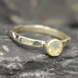 Ethiopian Opal ring in a dainty boho solitaire with a hammered band and oxidized silver bezel showing flashes of fire colors; the protective bezel and textured finish are comfortable for daily wear and help hide small scratches. Thoughtful October Birthstone gift for meaningful minimalist jewelry lovers.
Worn for office days, brunch dates, music festivals, casual weekends, and small weddings.