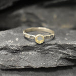 Ethiopian Opal ring in a dainty boho solitaire with a hammered band and oxidized silver bezel showing flashes of fire colors; the protective bezel and textured finish are comfortable for daily wear and help hide small scratches. Thoughtful October Birthstone gift for meaningful minimalist jewelry lovers.
Worn for office days, brunch dates, music festivals, casual weekends, and small weddings.