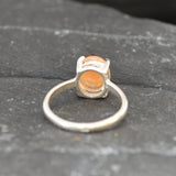 Ethiopian Fire Opal Solitaire Ring in sterling silver with a cabochon cut oval stone showing flashes of fire colors. Opal is linked to creativity, inspiration, and emotional balance, making it a meaningful October birthstone gift. A thoughtful choice for birthdays, anniversaries, promise rings, or engagements. Suitable for daily wear, weddings, and classic elegant occasions.