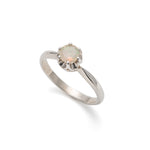 Natural Fire Opal Solitaire Ring in sterling silver with a round cut stone held in a secure setting. The opal glows with flashes of fire colors, making it a timeless choice for a dainty promise ring or engagement ring. Fire Opal, the October birthstone, is believed to bring passion, inspiration, and joy. A meaningful gift for birthdays, anniversaries, and special milestones. Perfect for weddings, engagements, family gatherings, or everyday wear.