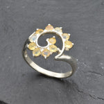 Opal Spiral Ring in sterling silver designed as a sunburst swirl statement jewelry piece offering radiant flashes of fire colors and boho charm, believed to inspire creativity and positivity, making it a thoughtful October birthstone gift idea. Perfect to wear at weddings, parties, and special occasions for a vibrant standout look.