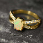 Opal Ring with split shank band and CZ pave setting showing flashes of fire colors, designed as elegant fine jewelry. Known for its emotional healing and creativity benefits, Opal is also the October birthstone and a thoughtful gift for birthdays or anniversaries. Perfect to wear at weddings, romantic dinners, and special evening celebrations.