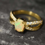 Opal Ring with split shank band and CZ pave setting showing flashes of fire colors, designed as elegant fine jewelry. Known for its emotional healing and creativity benefits, Opal is also the October birthstone and a thoughtful gift for birthdays or anniversaries. Perfect to wear at weddings, romantic dinners, and special evening celebrations.