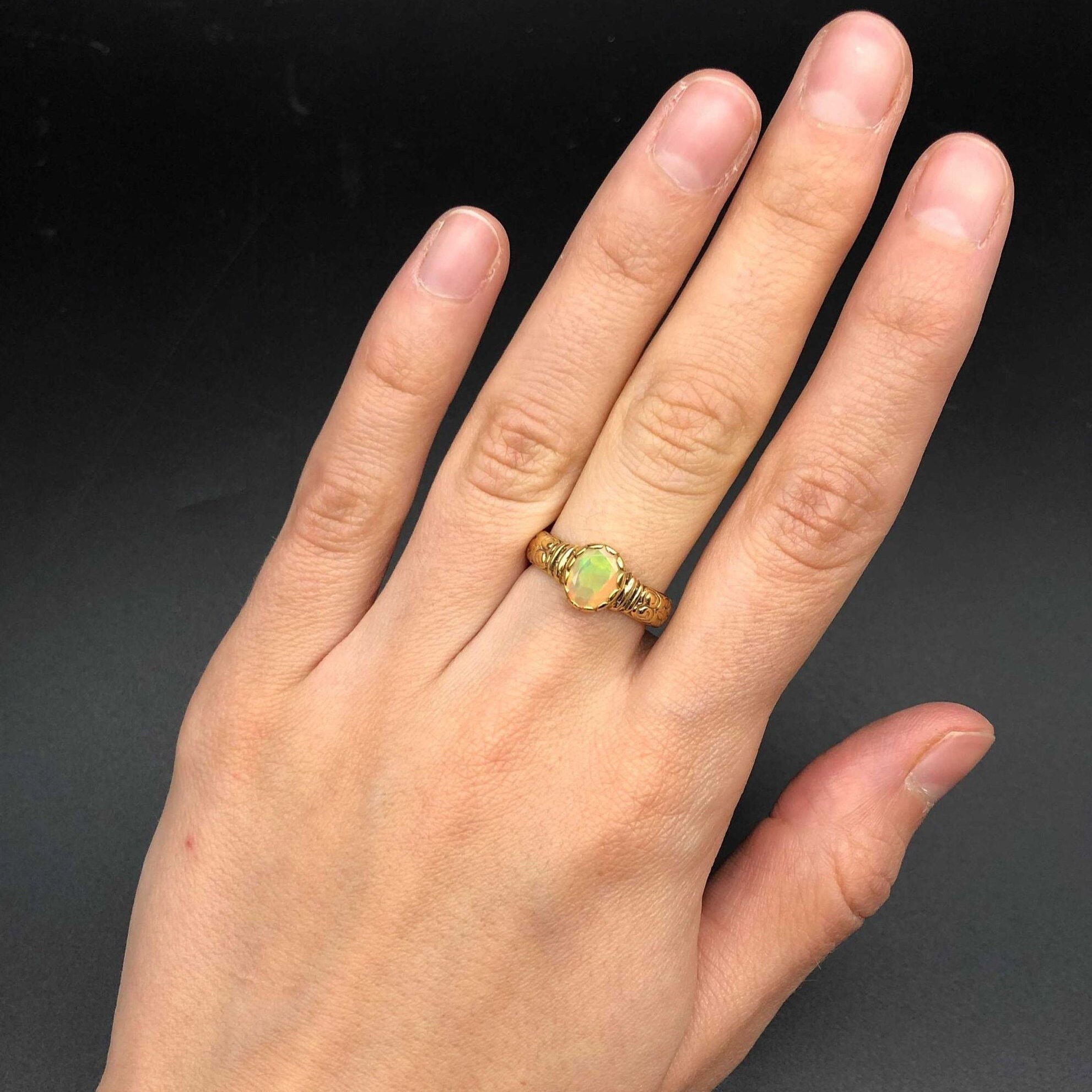 Ethiopian Opal Ring styled on middle finger with nude nails, blending boho elegance and fire flashes, making it a radiant October Birthstone piece for creativity and calmness, ideal for brunches, art shows, and cultural events.