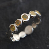 Yellow Ethiopian Fire Opal bezel tennis band eternity ring in sterling silver with diamond cut stones showing flashes of fire colors, a stylish jewelry design with bubble band details. Provides the benefit of a secure bezel setting and continuous gemstone glow, making it a meaningful October birthstone gift. Perfect for weddings, anniversaries, birthdays, and everyday wear.