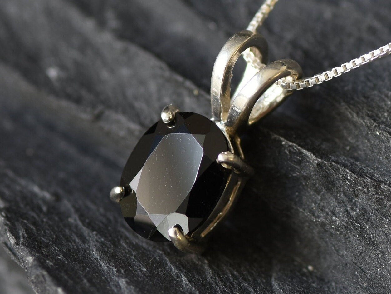Onyx pendant believed to promote grounding energy and boost inner stability.